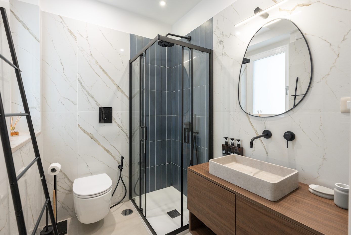 Marble bathroom with a walk-in shower and wooden vanity